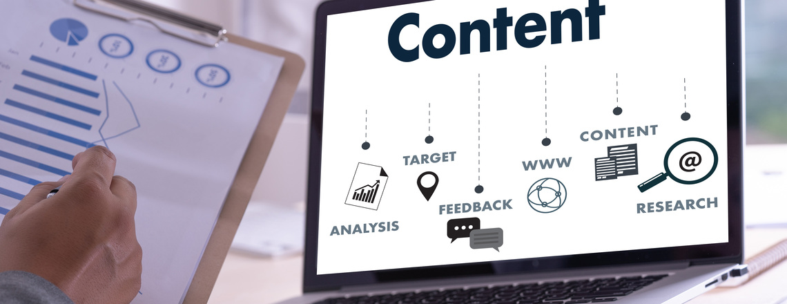 A person analyzes data next to a laptop screen displaying a content strategy flowchart, illustrating the role of planning in E-E-A-T SEO.