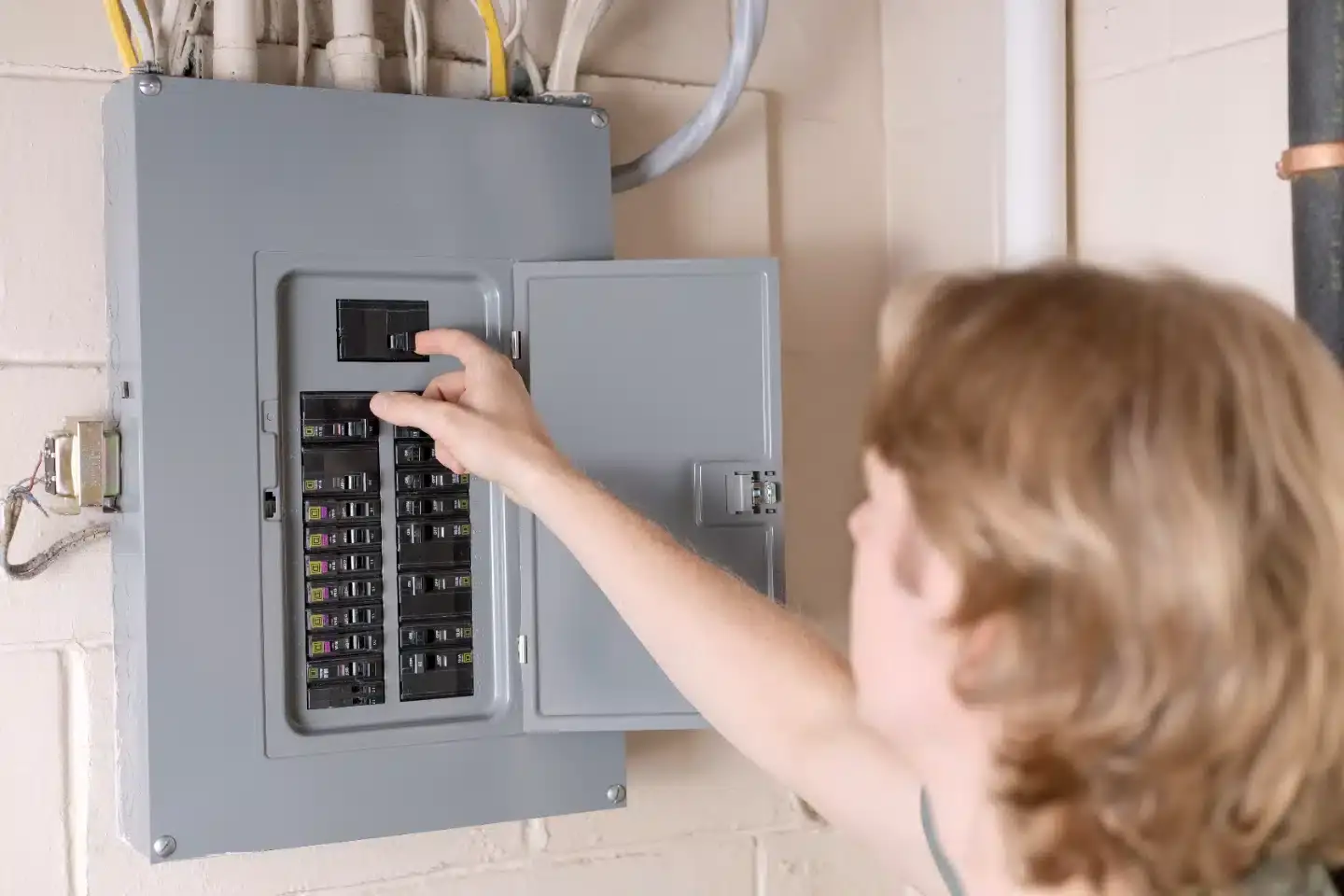 Electrician repairing a fuse in a home electrical panel
